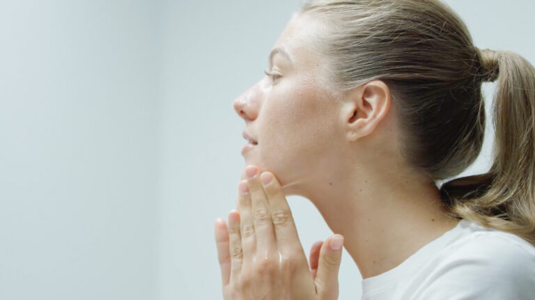 Woman applying face cream